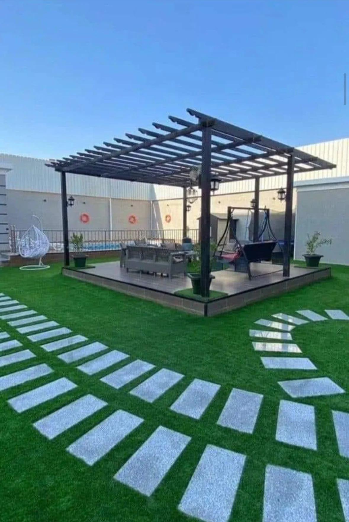 Outdoor lounge beneath a garden pergola