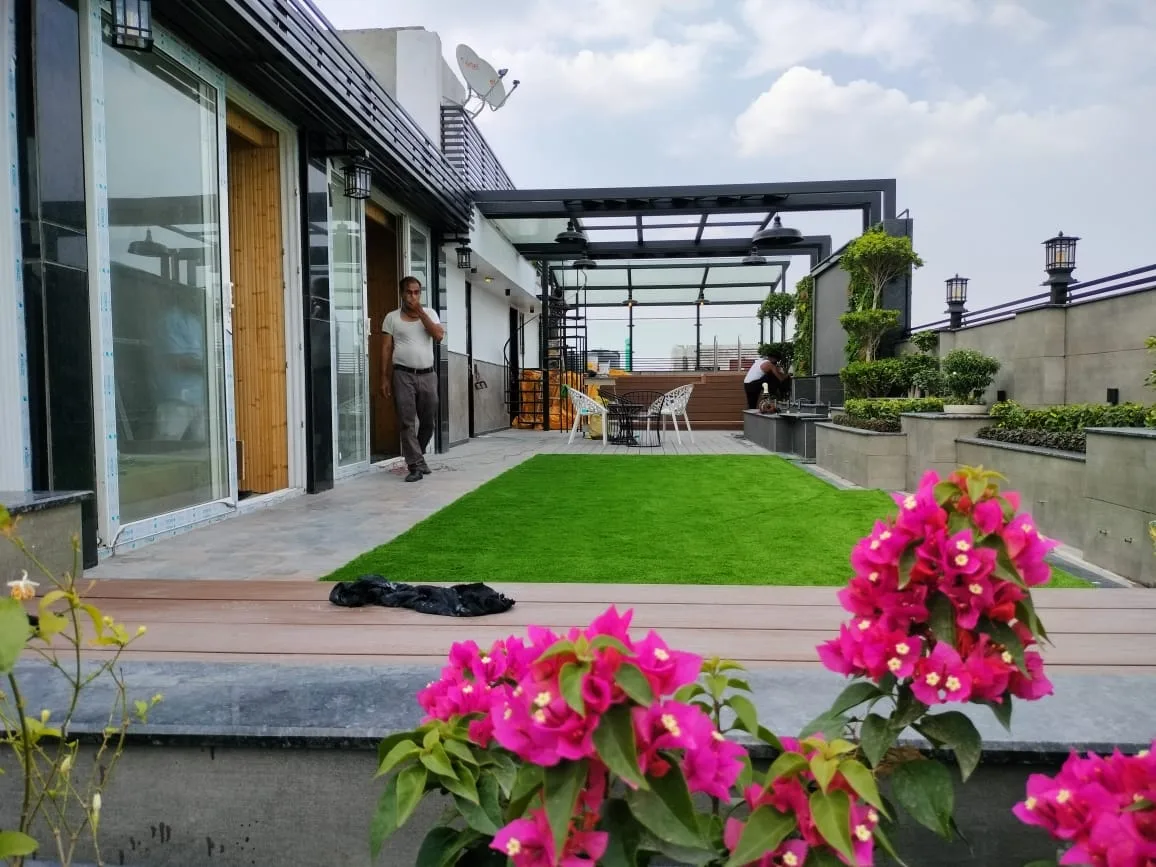 Terrace garden edged with flowering plants and lawn